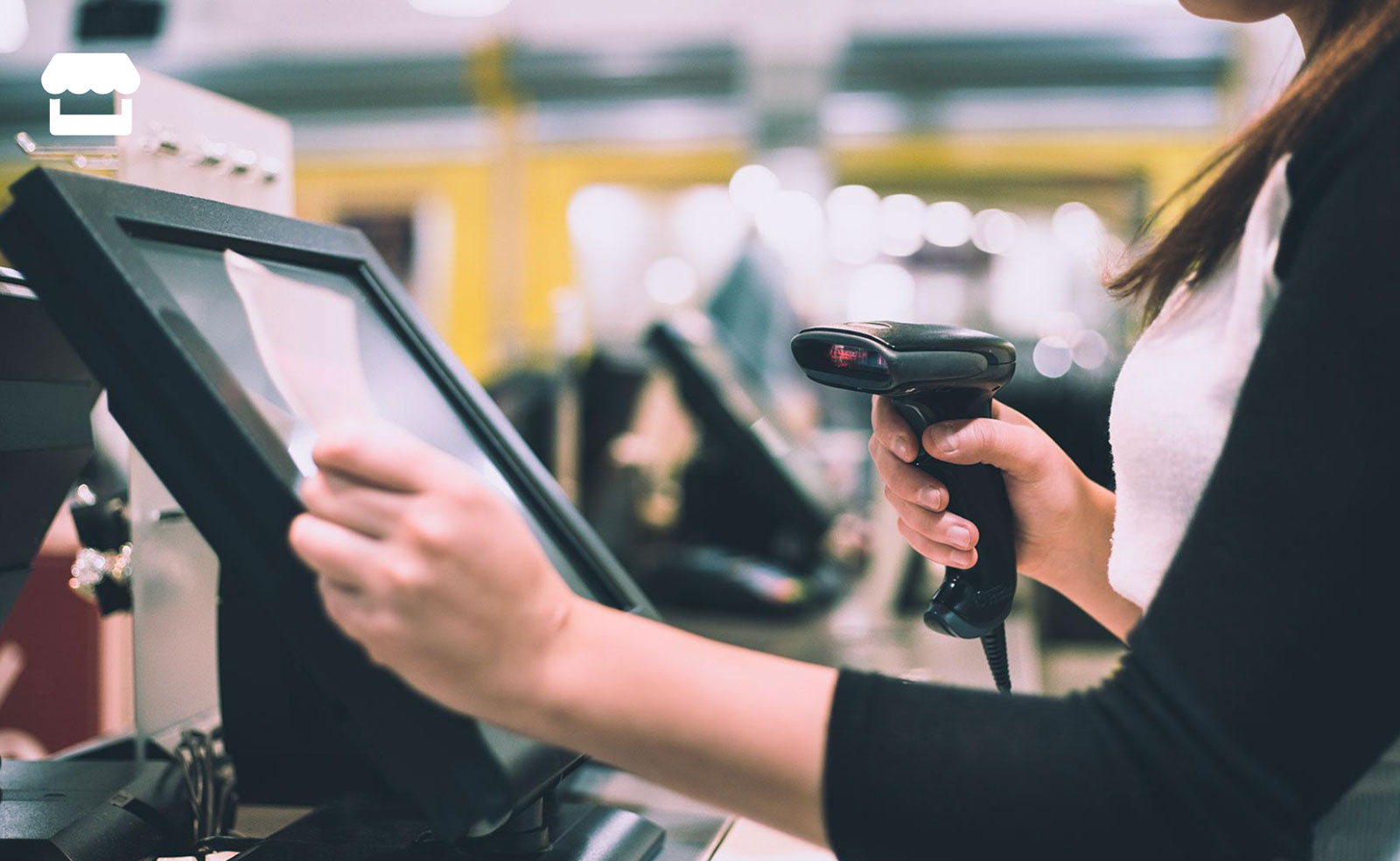 Retail assistant scanning a product at a tablet-based humble.OS till
